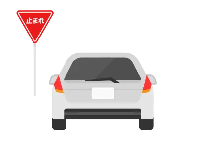 止まれの標識で一時停する自動車のイラスト