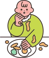 食べ物をベタベタとこぼしながら食べる赤ちゃん