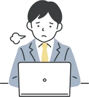 パソコンの前でため息をつく男性