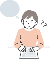 書類を書きながら考え事をする女性