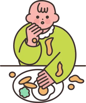 食べ物をベタベタとこぼしながら食べる赤ちゃん