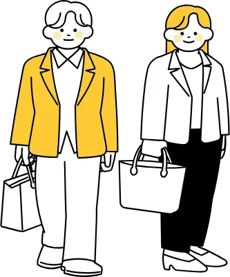 こちらを見て立っているオフィスカジュアルの男性と女性