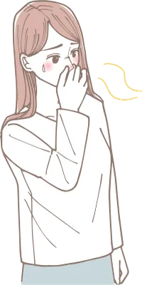 鼻をつまんで匂いを嗅がないようにしている女性