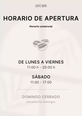 Cafetería sencilla en beige y negro con información sobre la hora de cierre