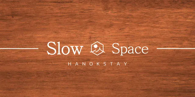 Hanok stay design with white eaves and a simplified symbolic logo of a landscape