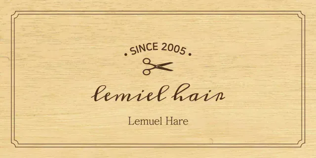 A classic-looking hair salon sign with black text and a scissors illustration