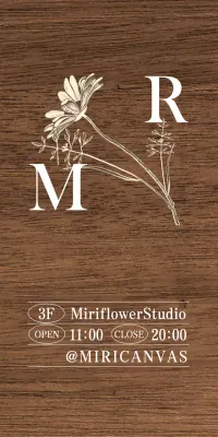 A vintage-inspired Flower Studio sign with white and ivory text and floral illustrations.