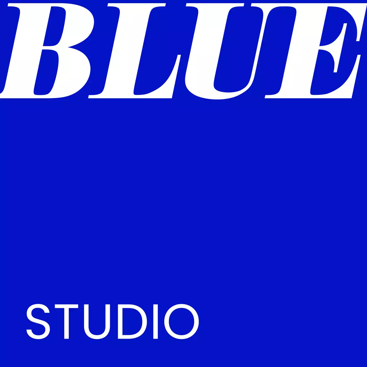 A simple storefront sign with blue and white Blue Studio text and a solid color background.