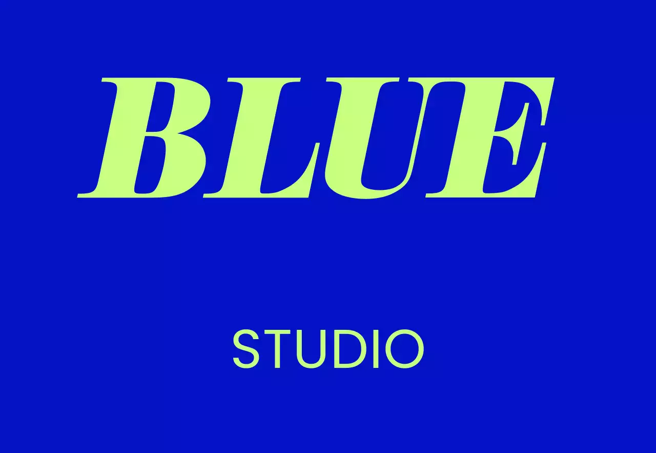 A simple storefront sign with blue and white Blue Studio text and a solid color background.