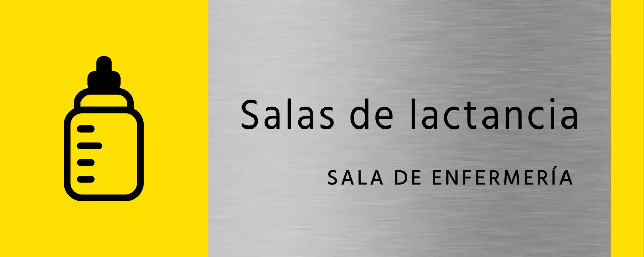 Sencilla señalización en amarillo y negro con el nombre de la sala de lactancia del edificio y un icono cuadrado de un biberón.