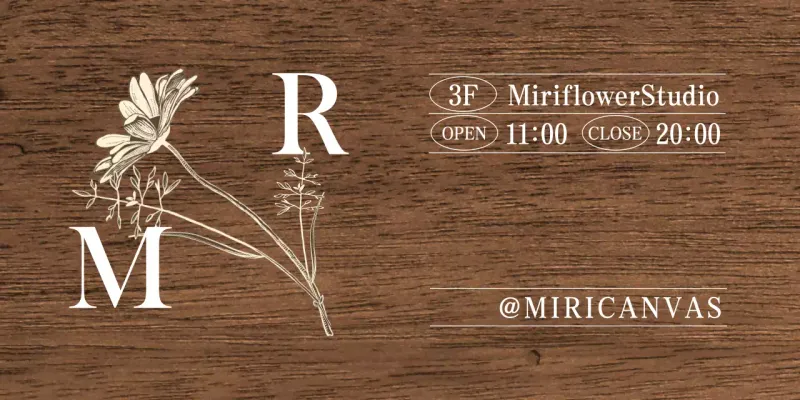 A vintage-inspired Flower Studio sign with white and ivory text and floral illustrations.